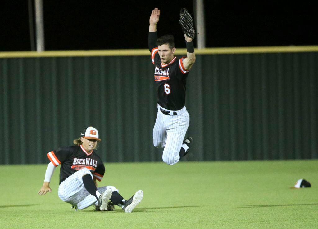 Rockwall outfielder Zach Henry (6) nearly collides into Bash Randle (8) after catching a fly...