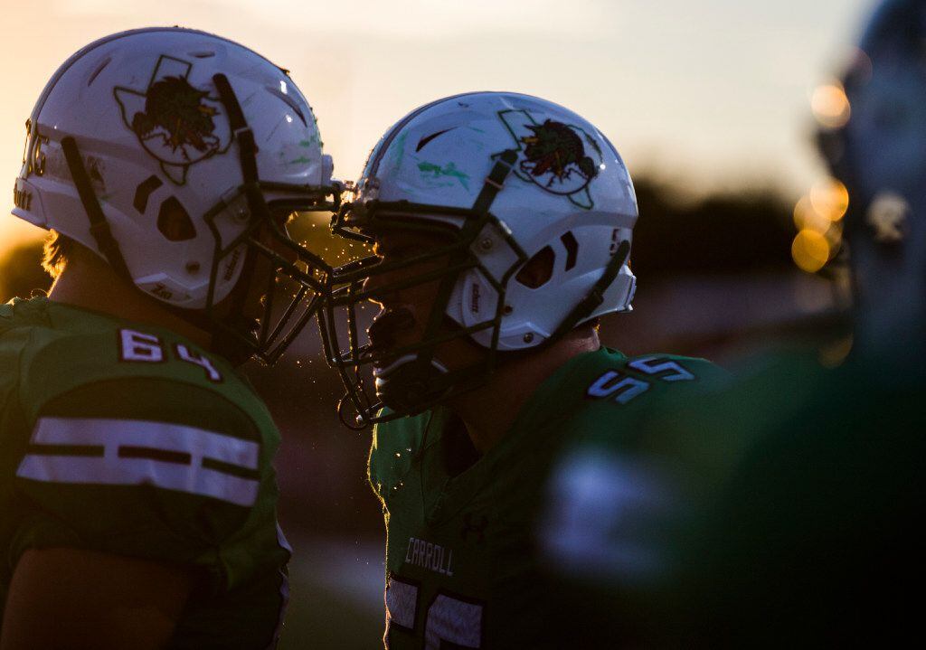 Southlake Carroll offensive lineman Ryan Miller (64) and offensive lineman Matt Leehan (55) hit helmets before their game against the Euless Trinity on Friday, September 30, 2016 at Dragon Stadium in Southlake, Texas.
(Ashley Landis/The Dallas Morning News)
 ORG XMIT: DMN1609302146336442