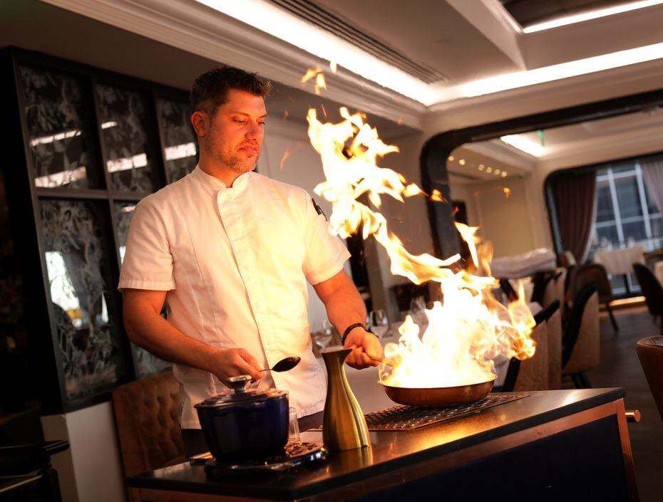 Executive chef Eric Dreyer cooks with high flames in the middle of the dining room at Monarch.