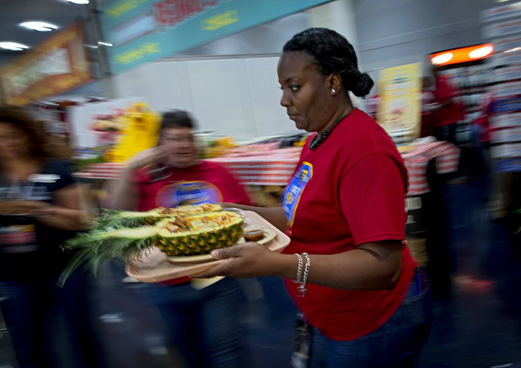 Felecia Mitchem carries Caribbean pineapple korn-a-copia to the judges' table during the 2016 Big Tex Choice Awards Sunday, August 28, 2016 at Fair Park in Dallas. The annual event, held ahead of the State Fair of Texas, recognizes the best fried foods entered into consideration for sale at the fair. (G.J. McCarthy/The Dallas Morning News)
