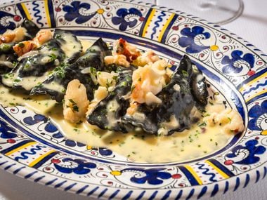 When New York style Italian restaurant Carbone opens in Dallas, it'll serve pasta, salad and more in a glamorous dining room. The mezzaluna is lobster and shrimp ravioli made with a squid ink dough and served in tarragon cream sauce.
