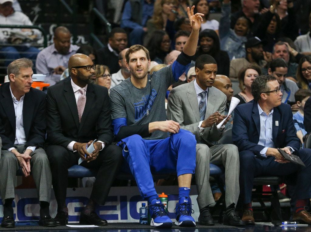 Dallas Mavericks forward Dirk Nowitzki (41) waves from the bench during the first half of a...