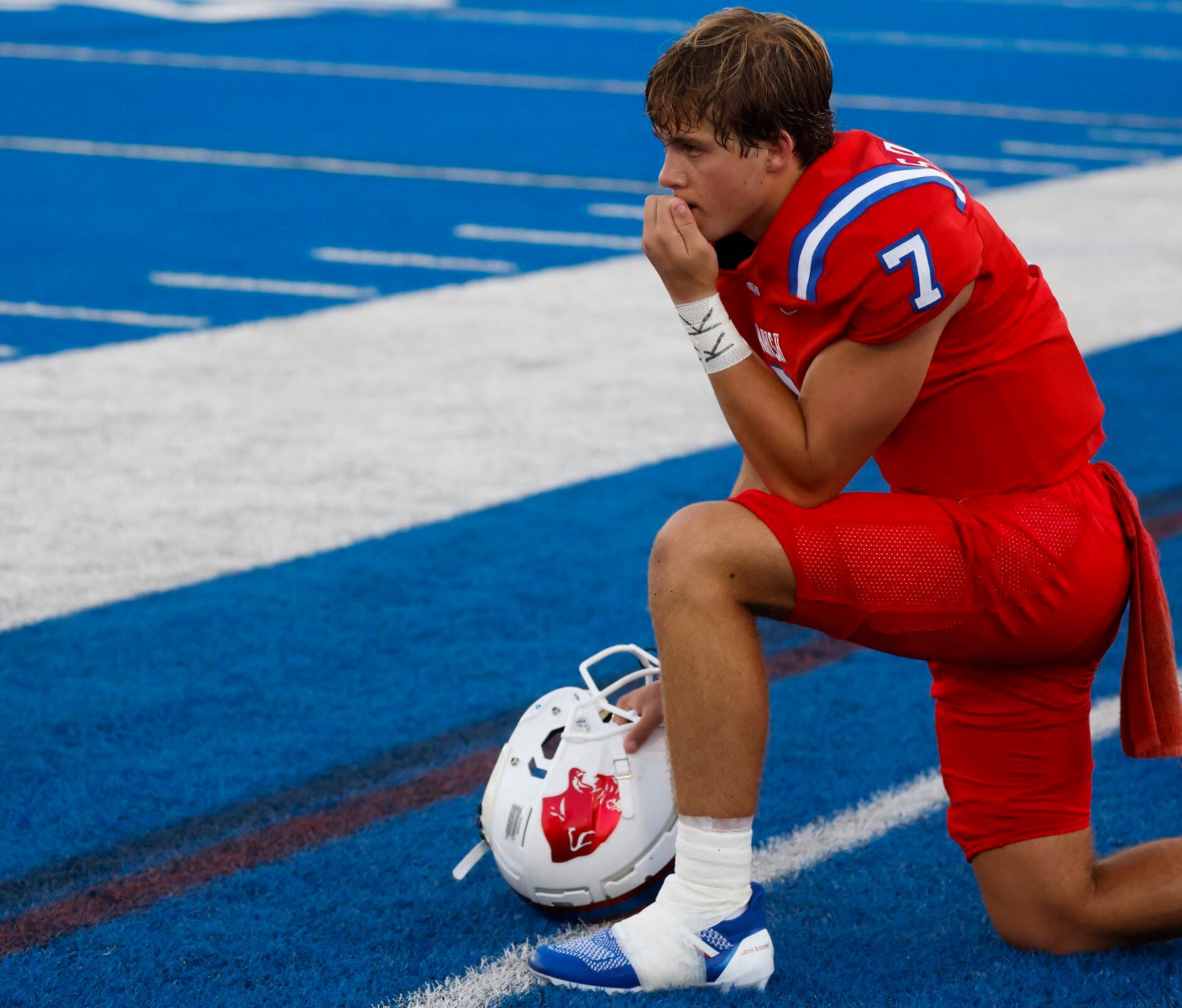 Parish Episcopal School’s QB Sawyer Anderson kneels in the sideline during the first half of...