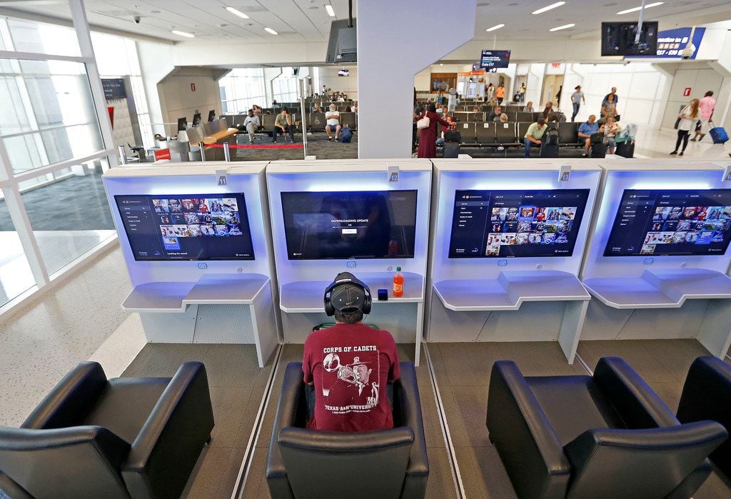 Traveler Chris Debruhl plays an online game while waiting for his flight at Gaemway next to the gate 16 inside Terminal E of Dallas/Fort Worth International Airport in DFW Airport, Texas, Friday, July 6, 2018. 