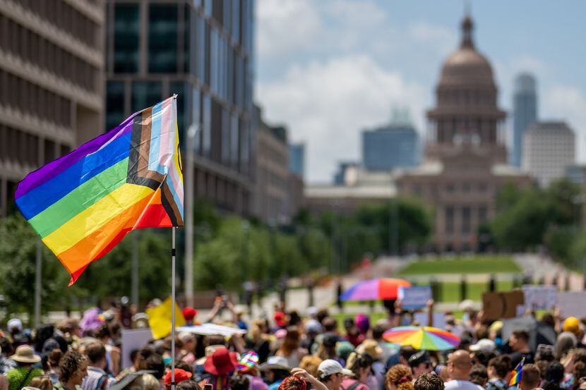 A Pride flag is seen held up in a crowd during preparation for a Queer March to the Texas...