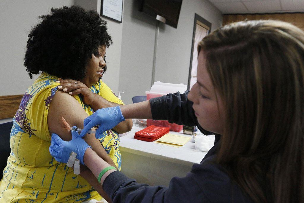 Nicole Stout, a Franklin County Public health nurse, gives  a measles shot to Nicole...