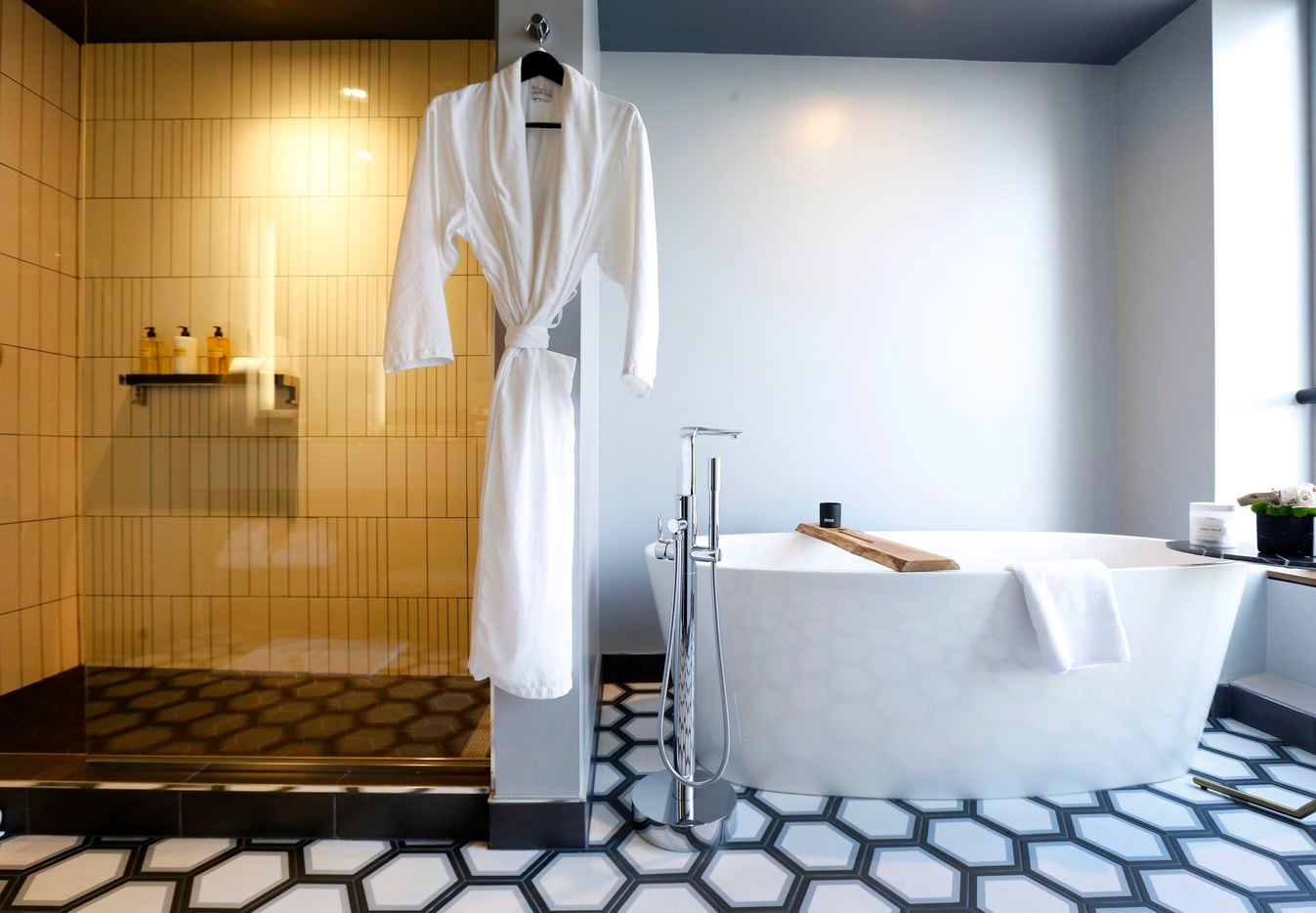 A tub and walk-in shower in the 219-room Thompson Dallas luxury hotel.