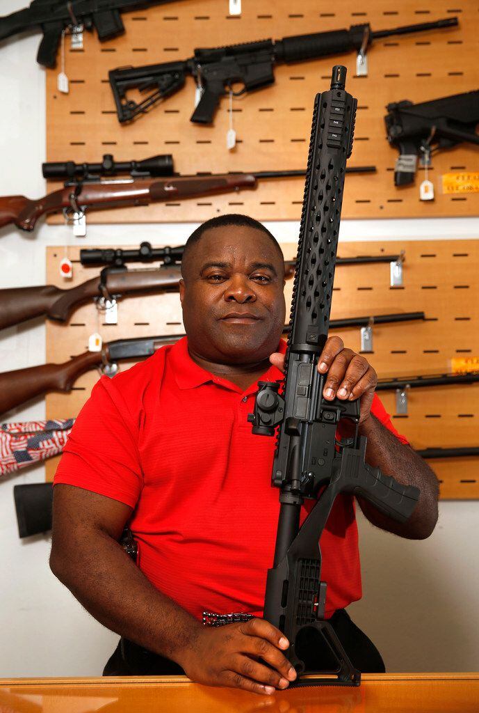 Michael Cargill, Central Texas Gun Works owner poses with an AR-15 with a bump stock attached in his store in Austin, Texas on Thursday, October 19, 2017. 
