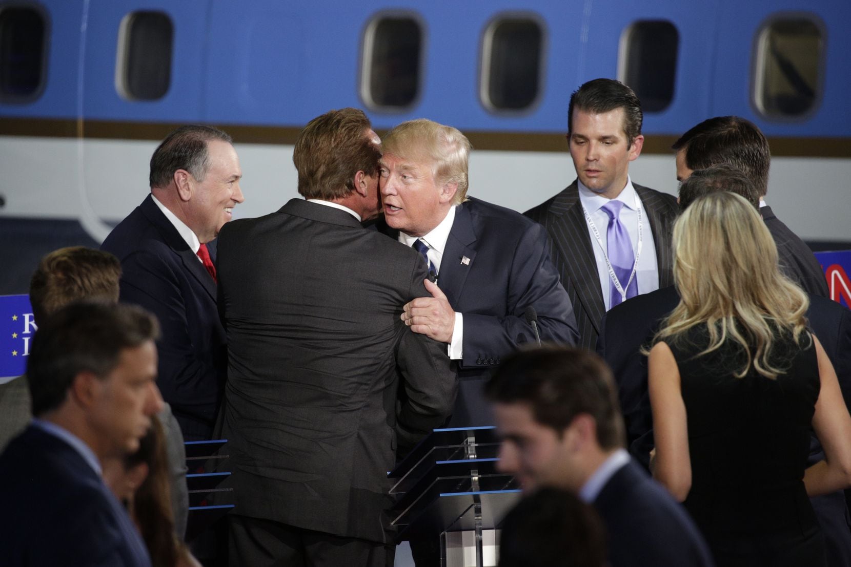 Arnold Schwarzenegger and Donald Trump share a hug at a Republican presidential debate at...
