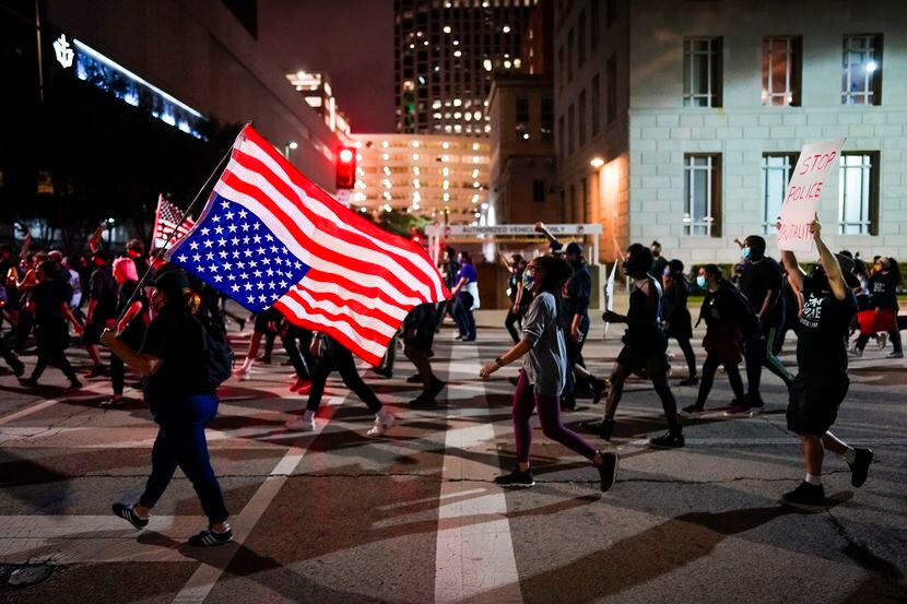 Demonstrators march on Ervay Street in downtown Dallas on Wednesday, Sept. 23, 2020....