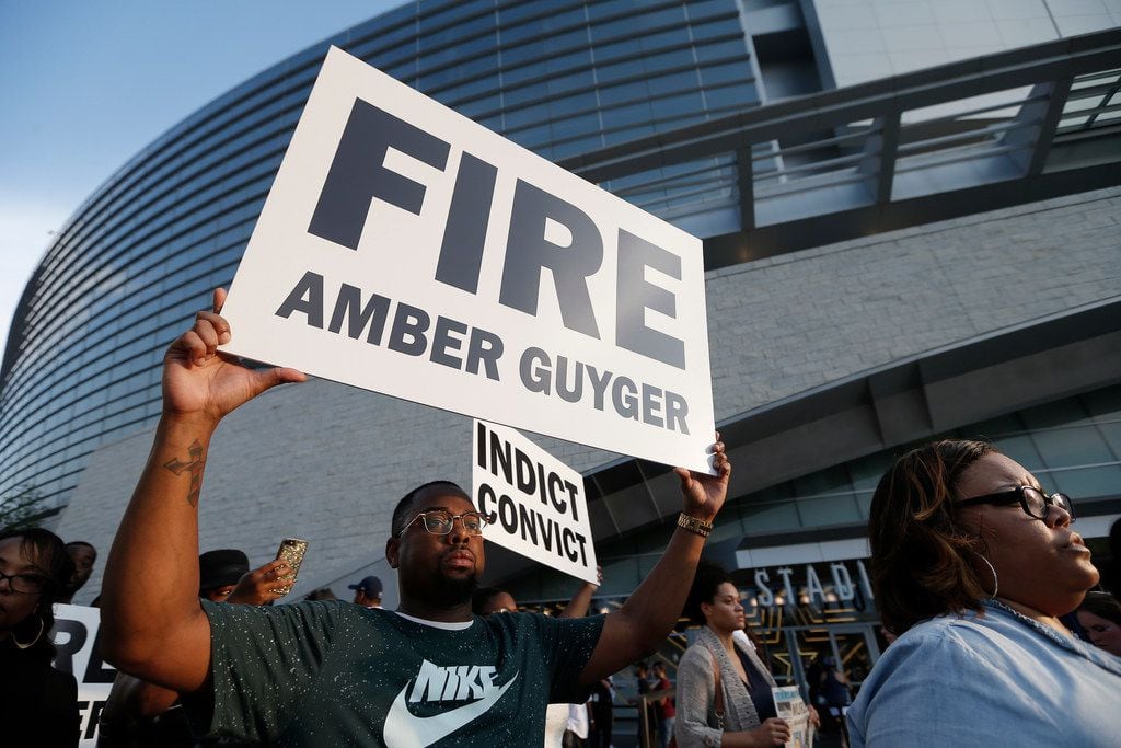 Demonstrators march around AT&T Stadium ahead of an NFL football game between the Dallas Cowboys and the New York Giants in protest of the recent killings of two black men by police, in Arlington, Texas, Sunday, Sept. 16, 2018. Botham Jean and O'Shae Terry were fatally shot by police in North Texas earlier in the month.