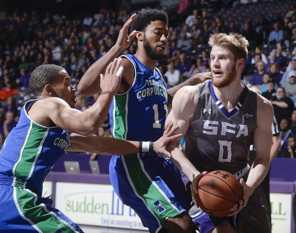 Stephen F. Austin State's Thomas Walkup (0) drives the baseline with Texas A&M-Corpus...