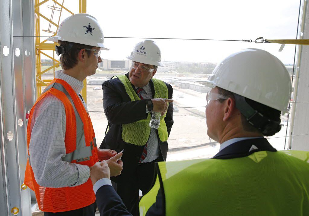 Frisco Mayor Maher Maso, center, talks with Omni's Brian Smith, left, and Jeff Smith in one...