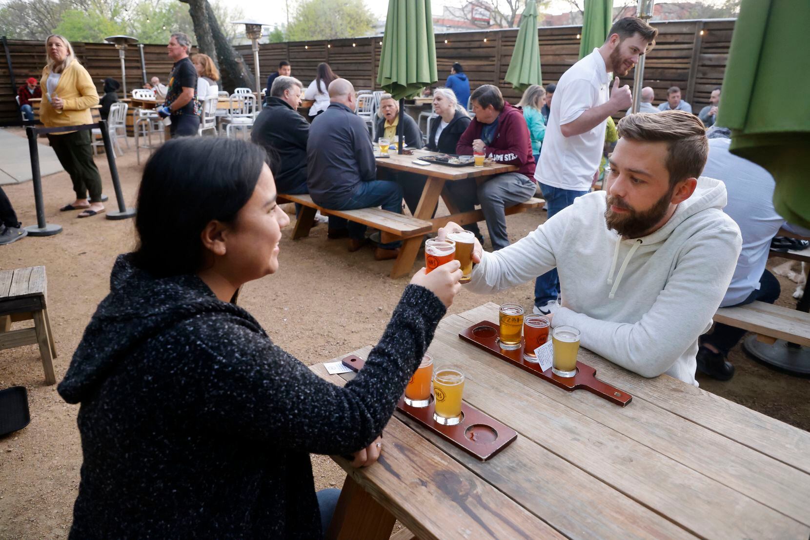 Dominica LoZada, left, and Patrick Jimision, right, of Grapevine, toast to their beer...