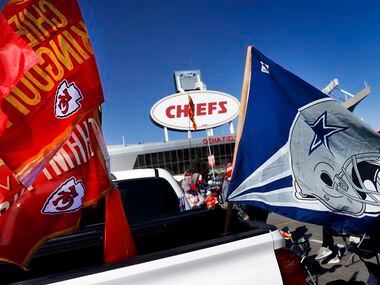 Dallas Cowboys and Kansas City Chiefs flags fly from the back of a pickup during a pregame...