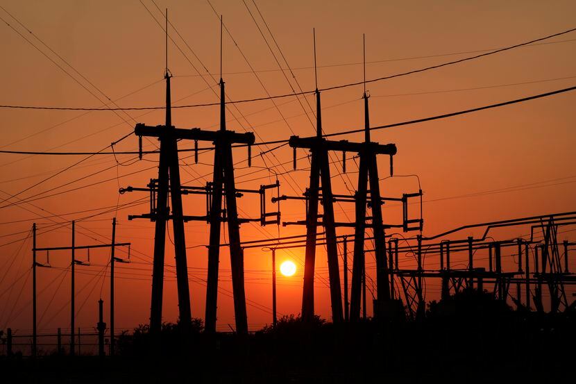 The sun sets through extreme humidity behind a Brazos Electric Power Cooperative substation...