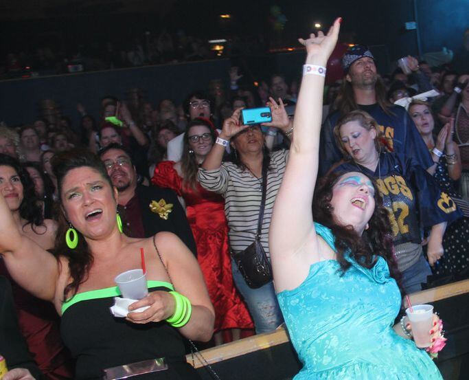 The audience gets into the spirit at a prom night party.