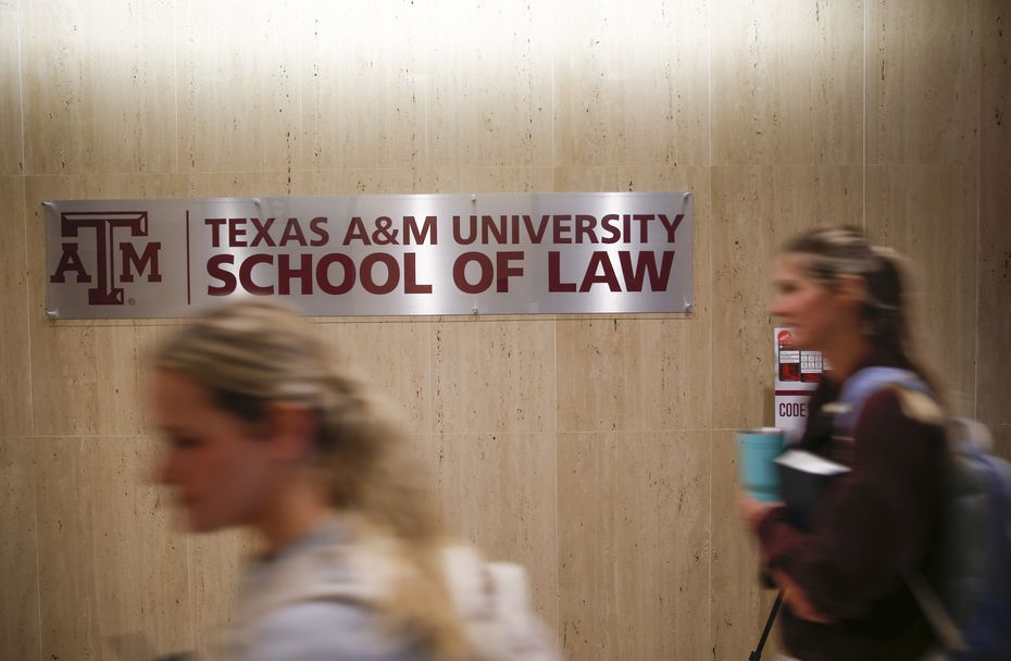 Students pass by a sign on Tuesday, March 29, 2022 at Texas A&M University School of Law in...