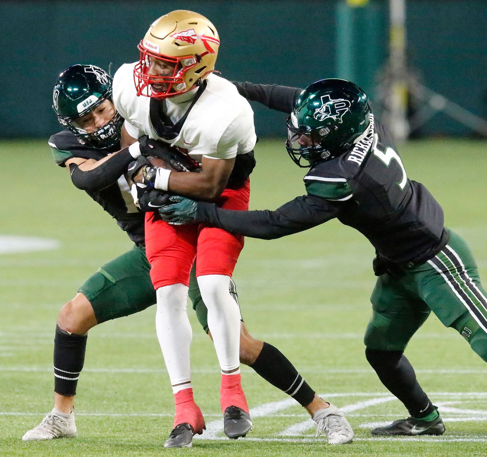 South Grand Prairie High School wide receiver Matthew Ramirez (10) is wrapped up by Prosper...