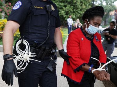 WASHINGTON, DC - JULY 29: U.S. Rep. Sheila Jackson Lee (D-TX) (R) is arrested by a member of U.S. Capitol Police as she participates in a civil disobedience during a protest outside Hart Senate Office Building on Capitol Hill July 29, 2021 in Washington, DC. Black women voting rights leaders and allies took part in a “Day of Action on Capitol Hill” event calling on the U.S. Senate to pass the For the People Act and end the filibuster. (Photo by Alex Wong/Getty Images)