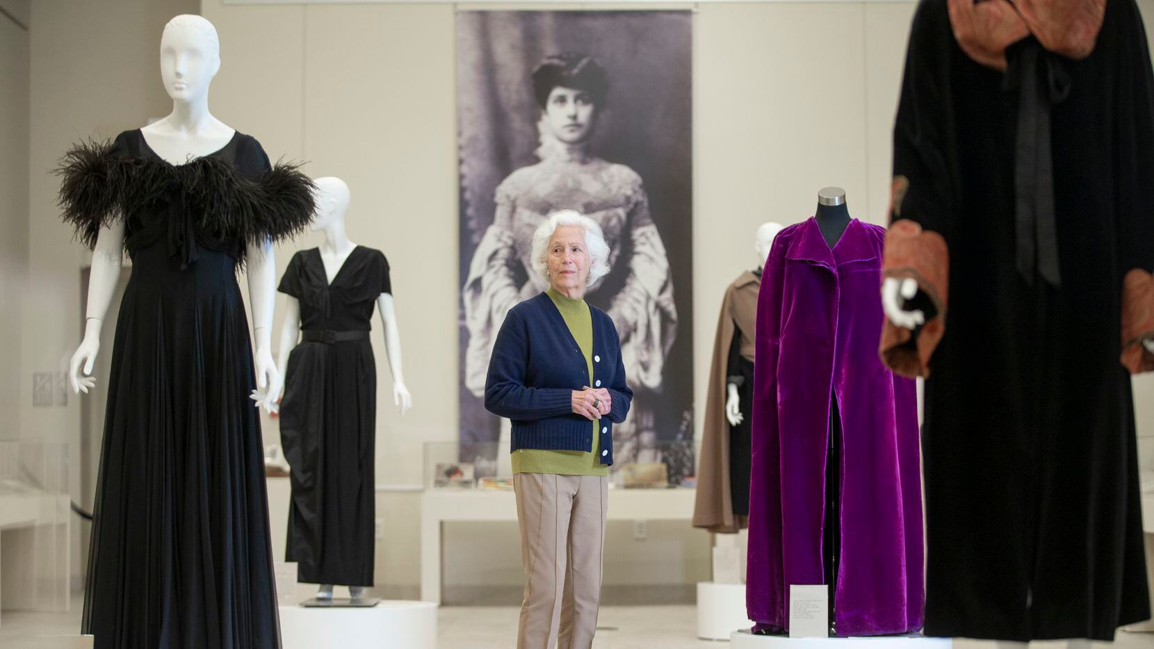 Jerrie Marcus Smith, 85, poses with coats and gowns from the Texas Fashion Collection featured in the exhibition “An Eye for Elegance: Carrie Marcus Neiman and the Women Who Shaped Neiman Marcus” at the Hillcrest Exhibition Hall in the Fondren Library at Southern Methodist University on Dec. 17, 2021.