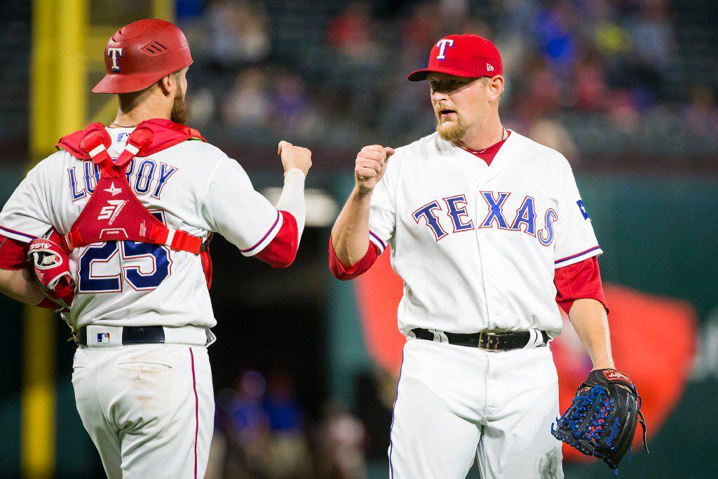 Texas Rangers pitcher Austin Bibens-Dirkx is congratulated by catcher Jonathan Lucroy after...
