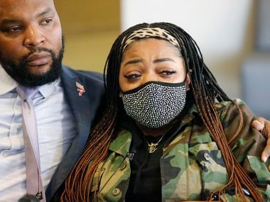 Civil rights attorney Lee Merritt (left) comforts LaChay Batts, sister of Marvin David Scott III, during a news conference at the Collin County Sheriff’s Office in McKinney on Friday, March 19, 2021.