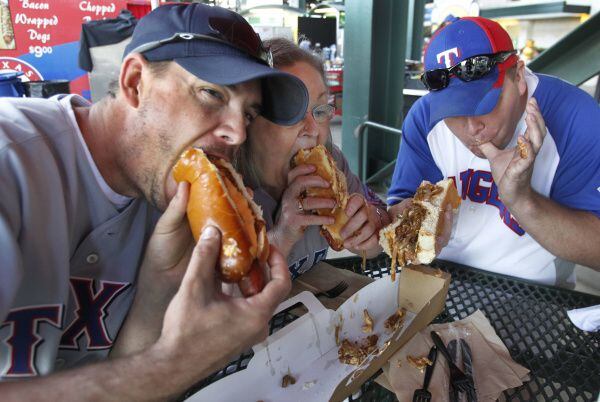 Rangers fans Aaron McElroy (left), Sue Colson and Weston McElroy chowed down on a Boomstick...