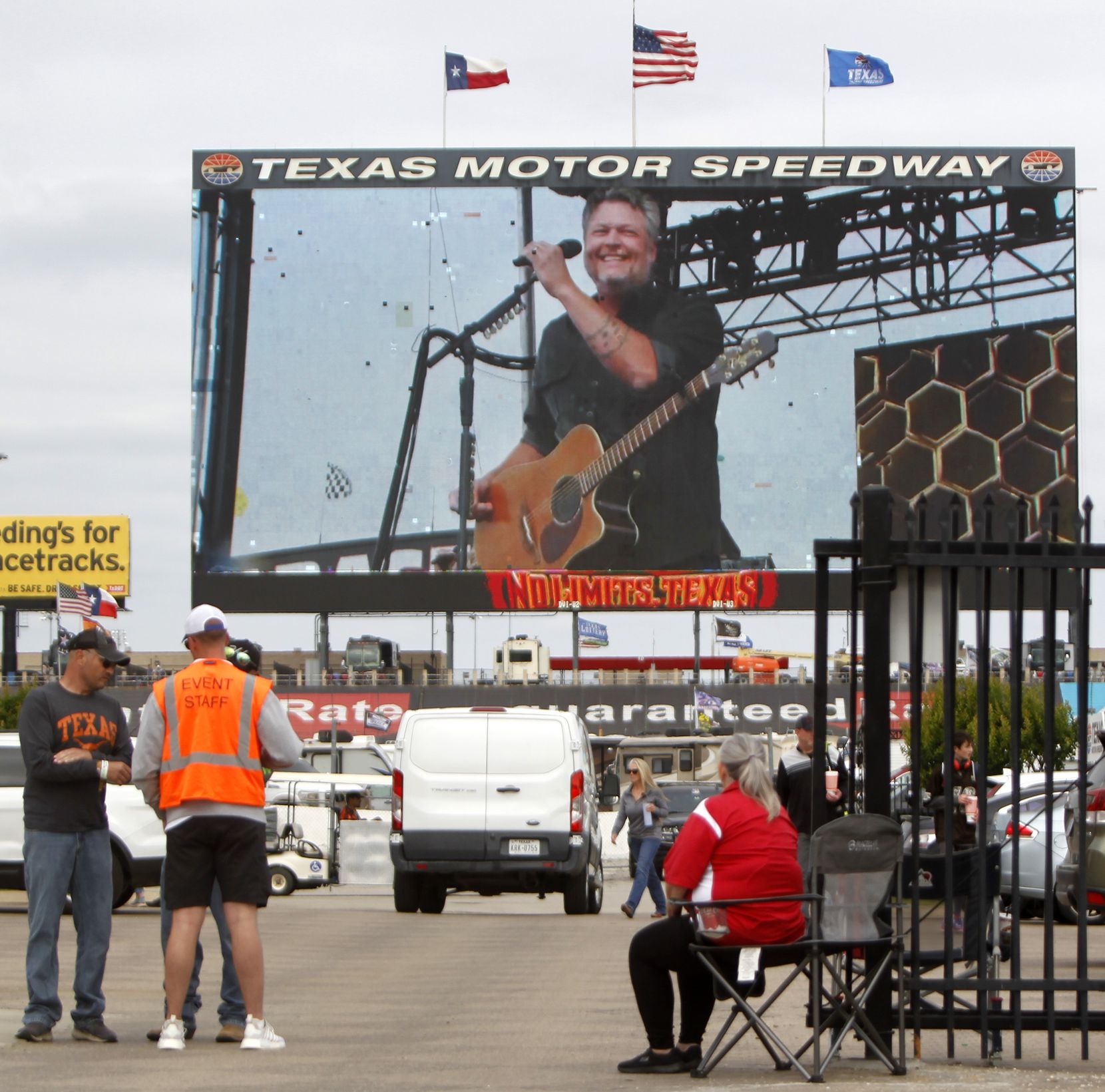 A member of the track security team pauses to take in part of Blake Shelton's concert. The...