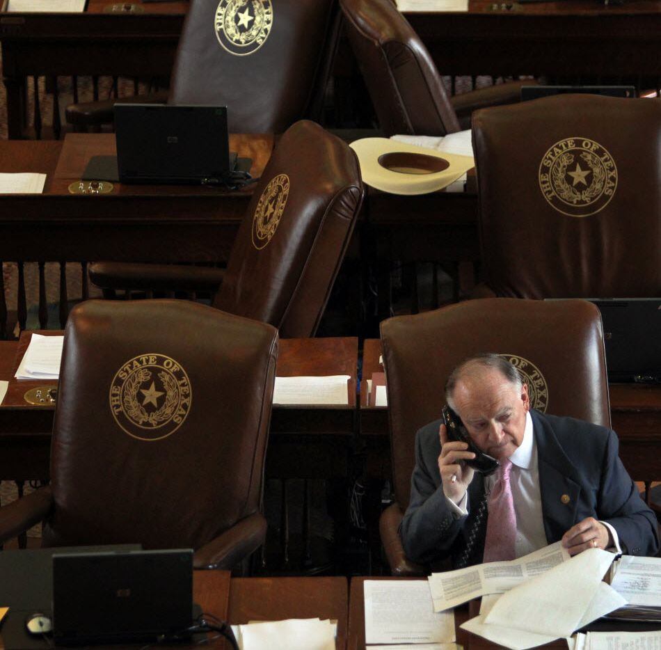 State representative Dan Flynn, R-Canton, works the phones during a break in the Sunday...