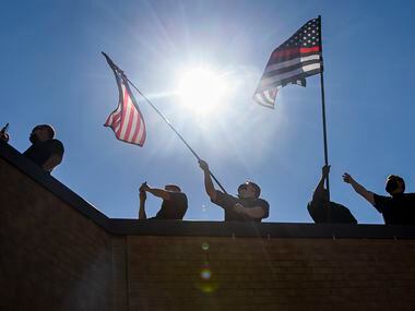 Dallas Fire-Rescue first responders at Fire Station 18 watch as the U.S. Navy Blue Angels...