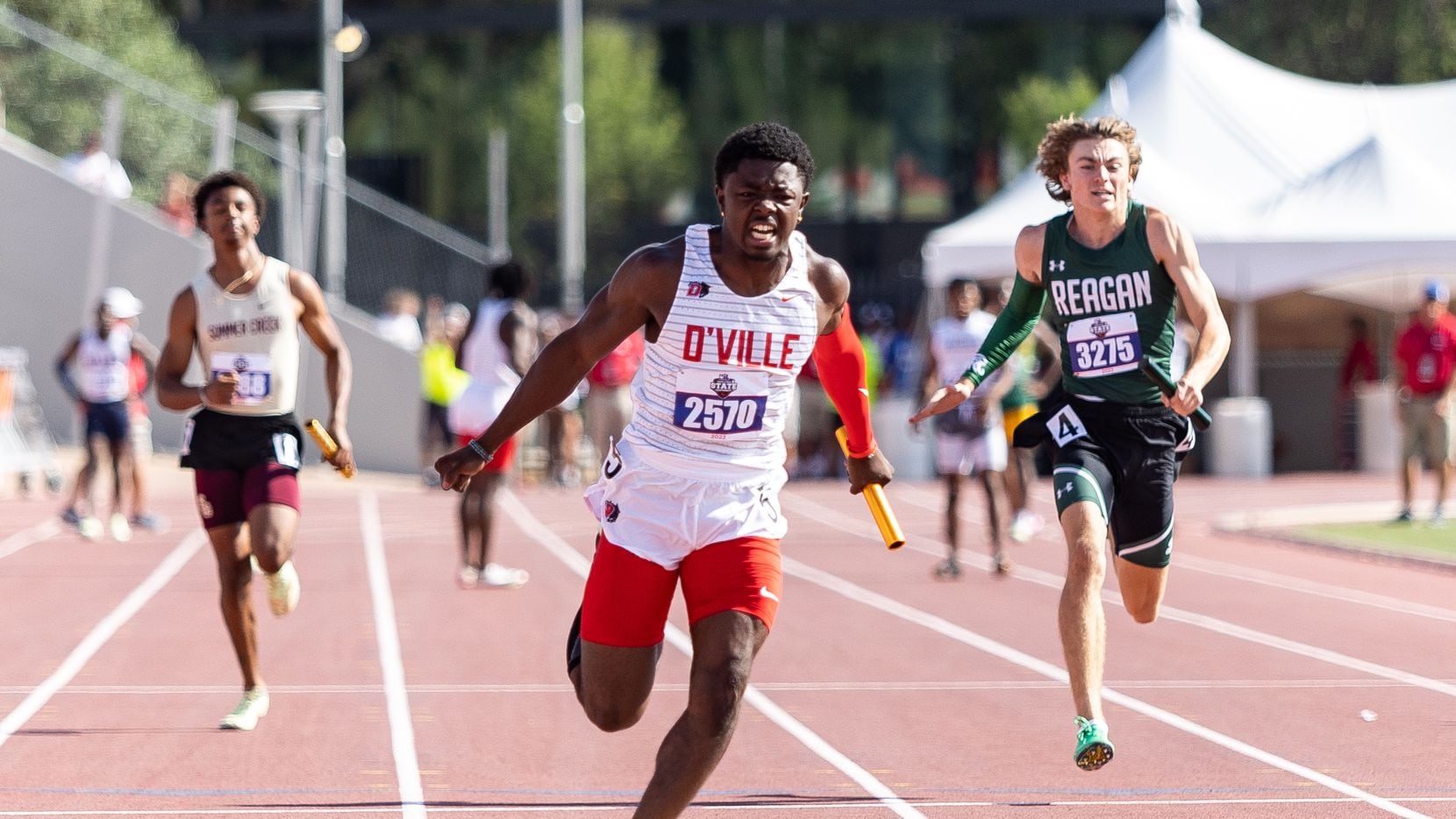 Jaylen Washington of Duncanville (center) races to victory in the Class 6A 4x100-meter relay...