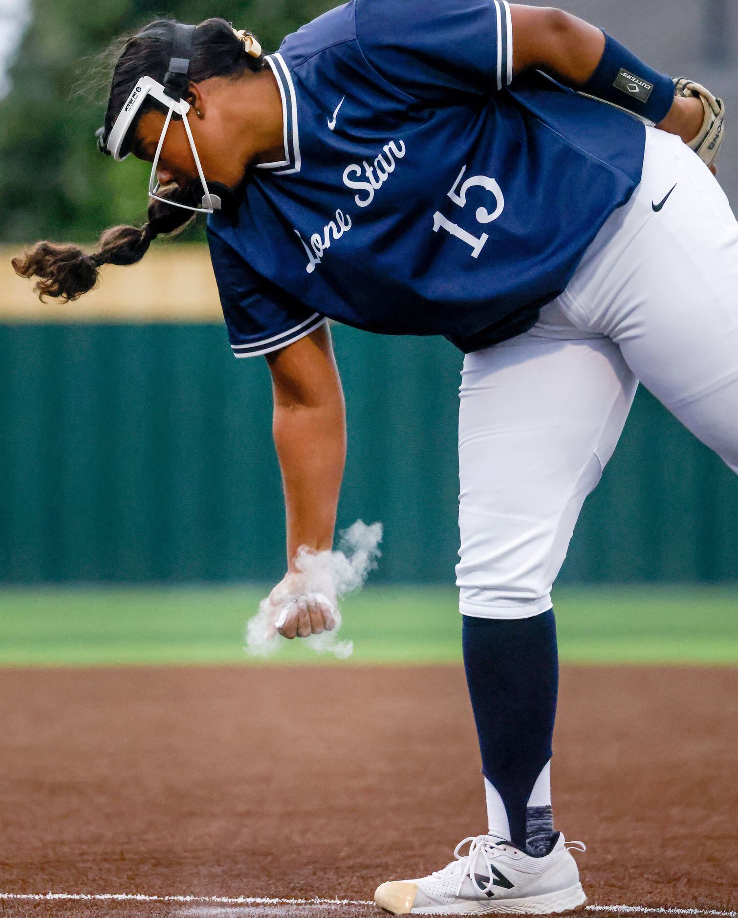 Frisco Lone Star pitcher Audrey Richardson (15) squeezes chalk in preparation of a pitch...