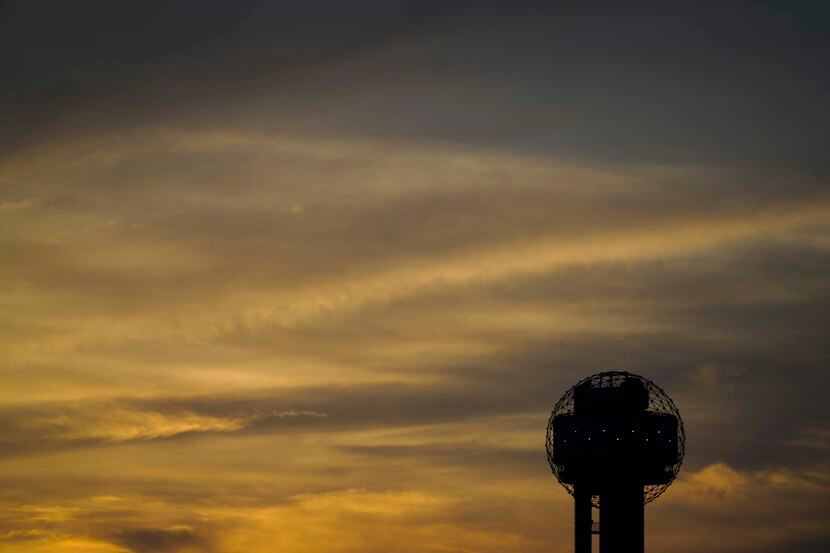 The sun sets behind Reunion Tower in Dallas. (Smiley N. Pool/The Dallas Morning News)