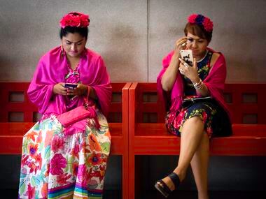 Elizabeth Martinez (right) applies makeup before the Frida Fest.