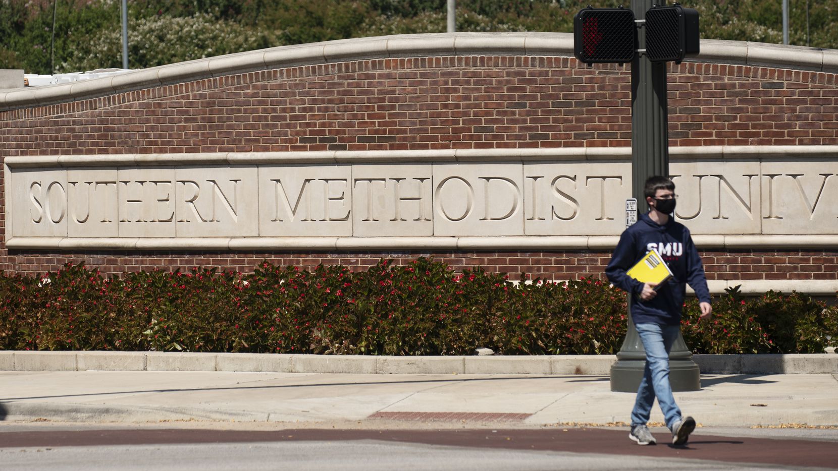 A student walks in front of the main entrance sign outside of the campus of Southern...