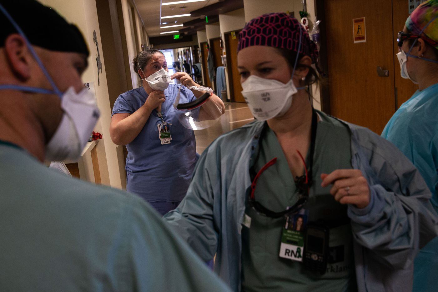 Rowley (center) suits up with personal protective equipment to help with a patient’s intubation in the COVID-19 Tactical Care Unit. Rowley described her help on the floor with patient care as “intermittent,” but said she jumps in to help her staff as needed. “I honestly like to interact,” she said.