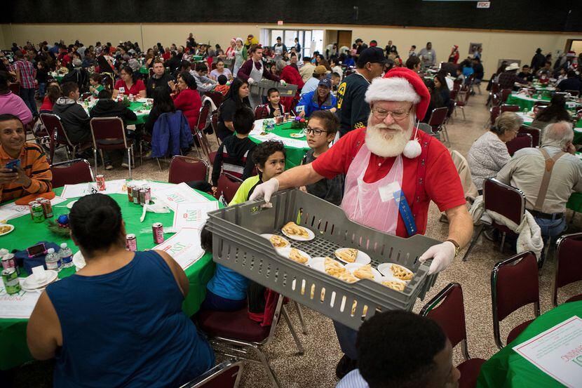 Volunteer James Dykes helps serve pie during the 29th Annual H-E-B Feast of Sharing at the...