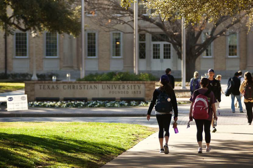 Students at Texas Christian University walk across University Boulevard on campus. A case of...