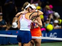 Victoria Azarenka of Belarus and Ashlyn Krueger of the United States embrace at the net...