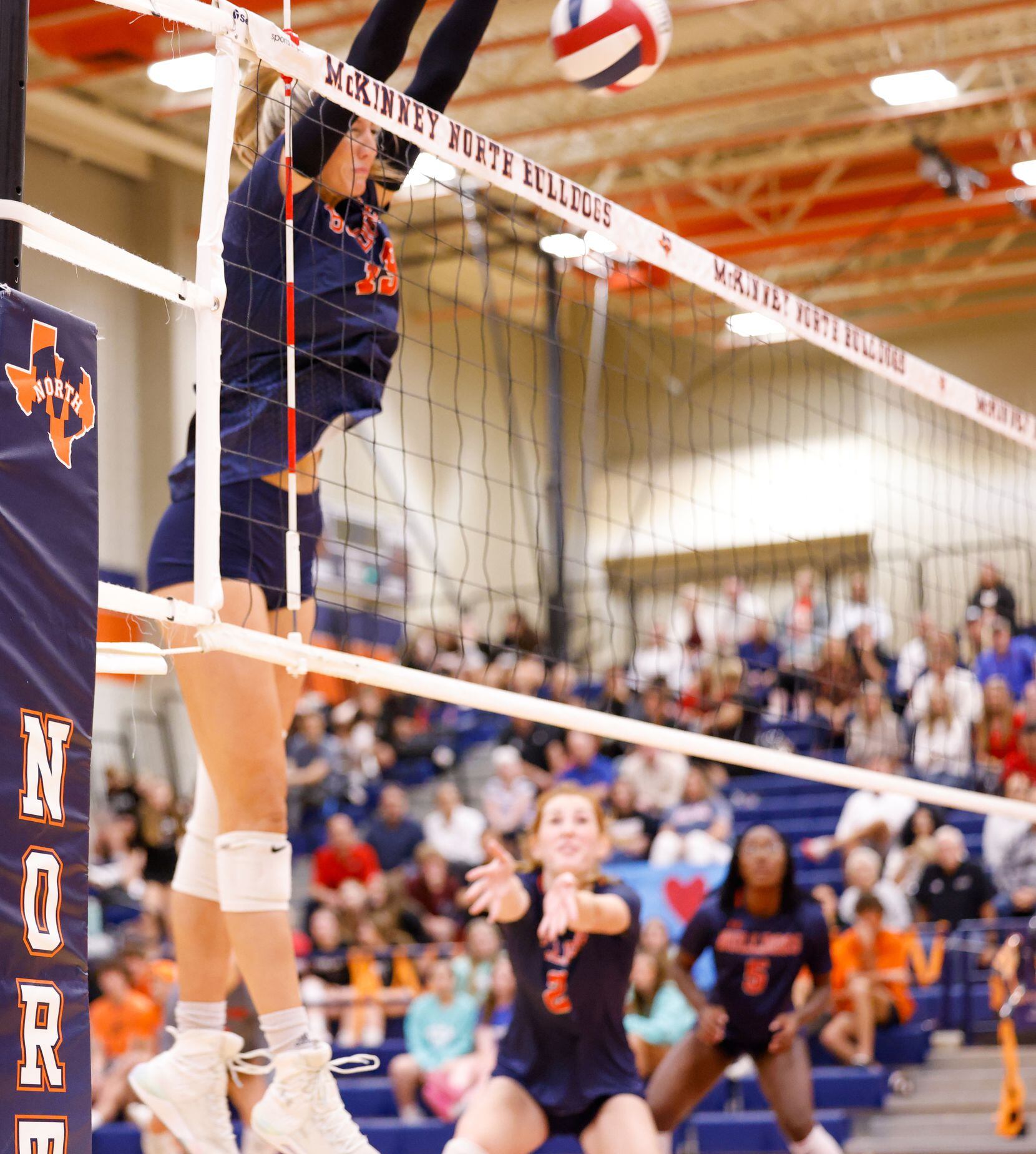 McKinney North Natalie Hughes (19) blocks a spike by Lovejoy in the final set of a match in...