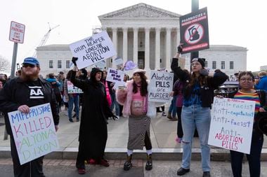Anti-Abortion demonstrators protest outside of the Supreme Court during a rally, March 26,...