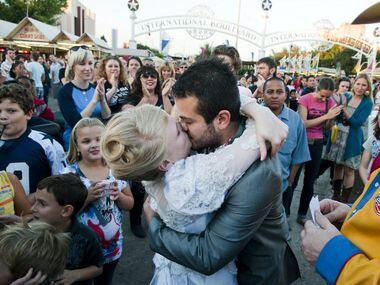 Sara Rice of Dallas kisses her husband Jose Luis Martinez Hernandez of Mexico City after...