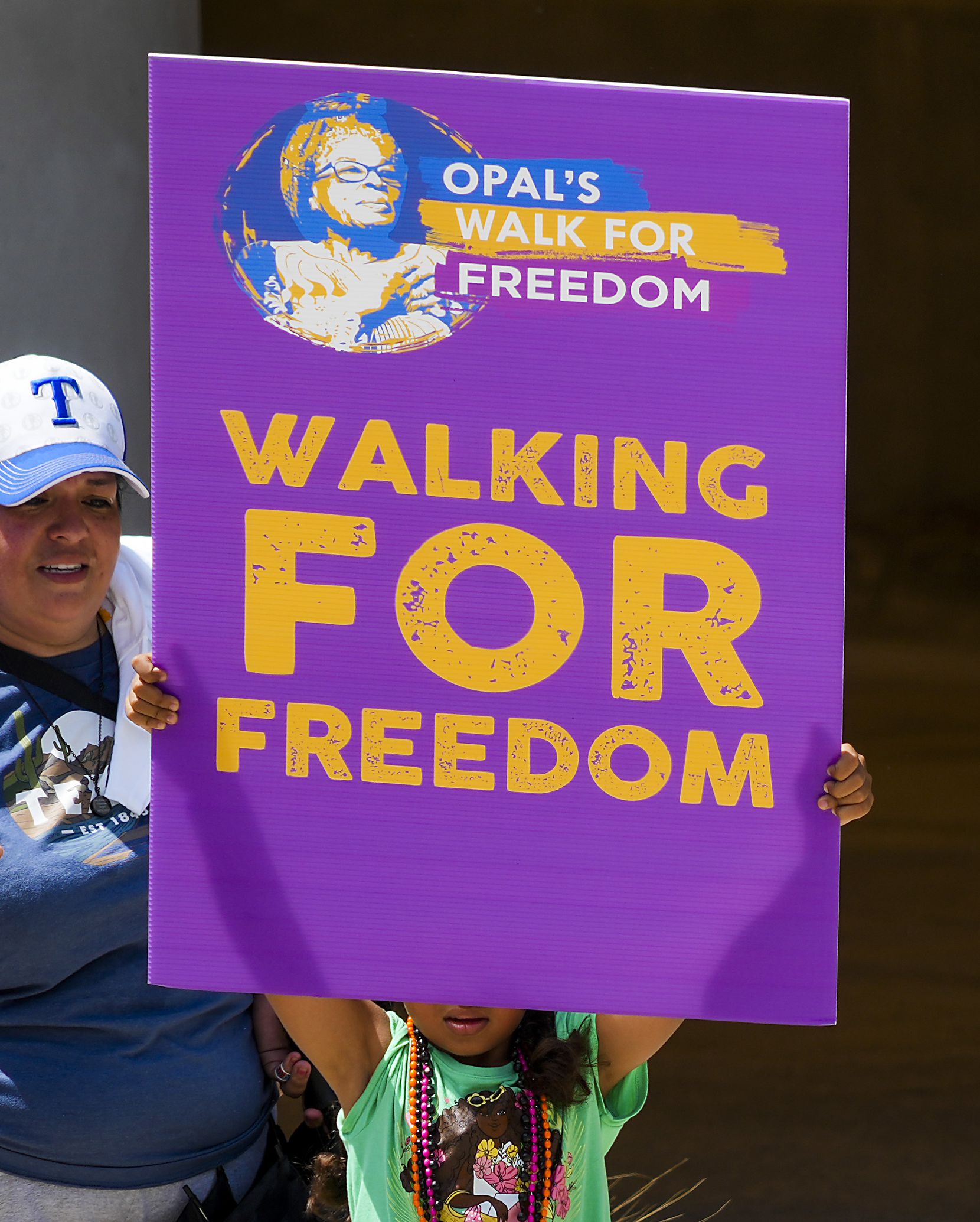 A youngster holds a sign during the 2022 Opal's Walk for Freedom on Saturday, June 18, 2022,...