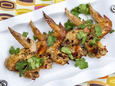 Glazed Sesame Chicken Wings dressed with cilantro and sesame seeds