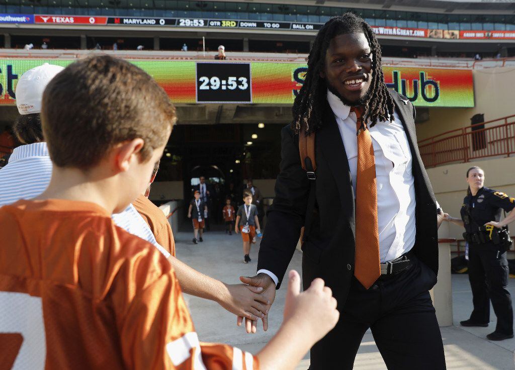 AUSTIN, TX - SEPTEMBER 02:  Malik Jefferson #46 of the Texas Longhorns shakes hands with fans before the game against the Maryland Terrapins at Darrell K Royal-Texas Memorial Stadium on September 2, 2017 in Austin, Texas.  (Photo by Tim Warner/Getty Images)