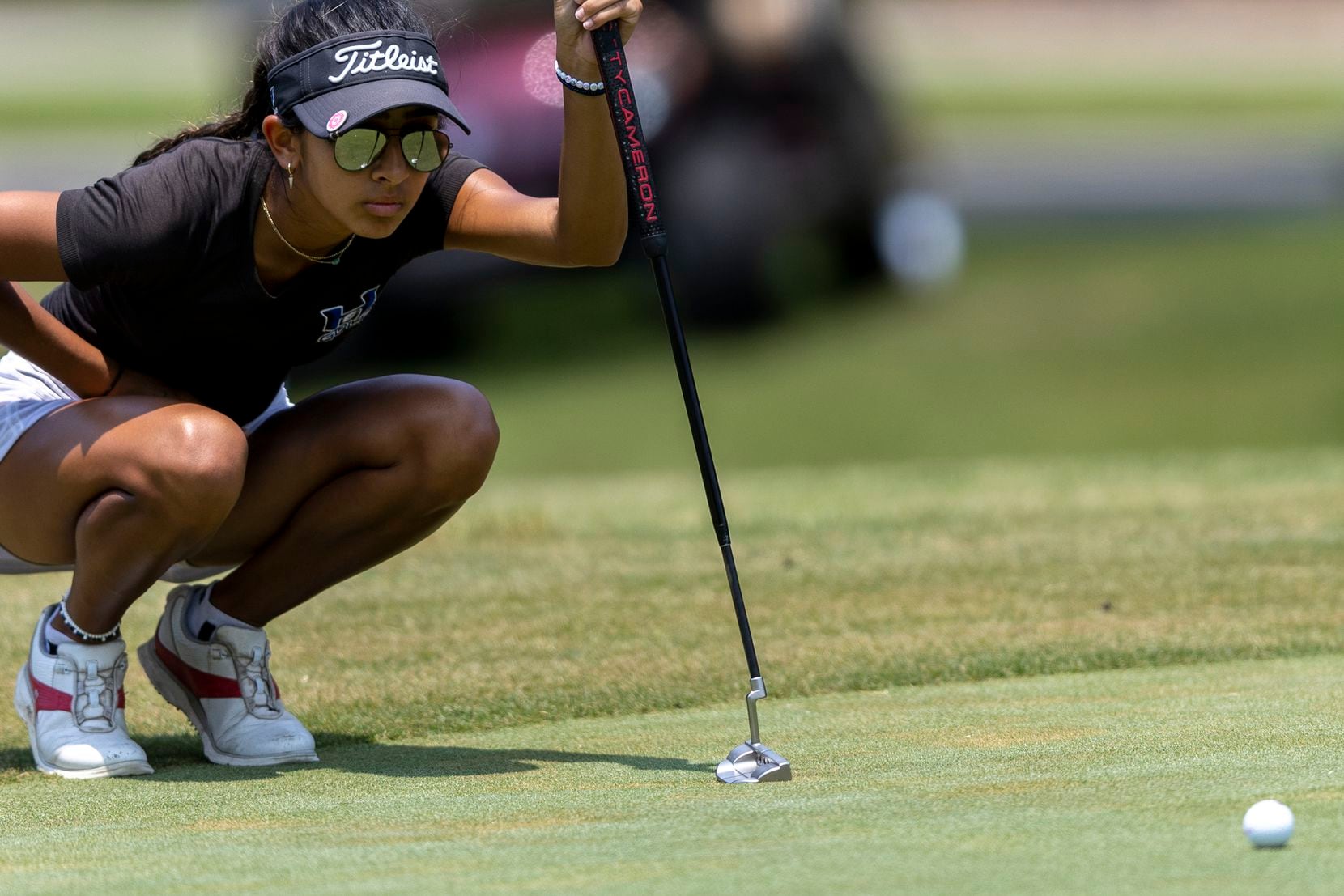 Hebron’s Symran Shah studies her shot on the 9th green during the 6A girls state golf...