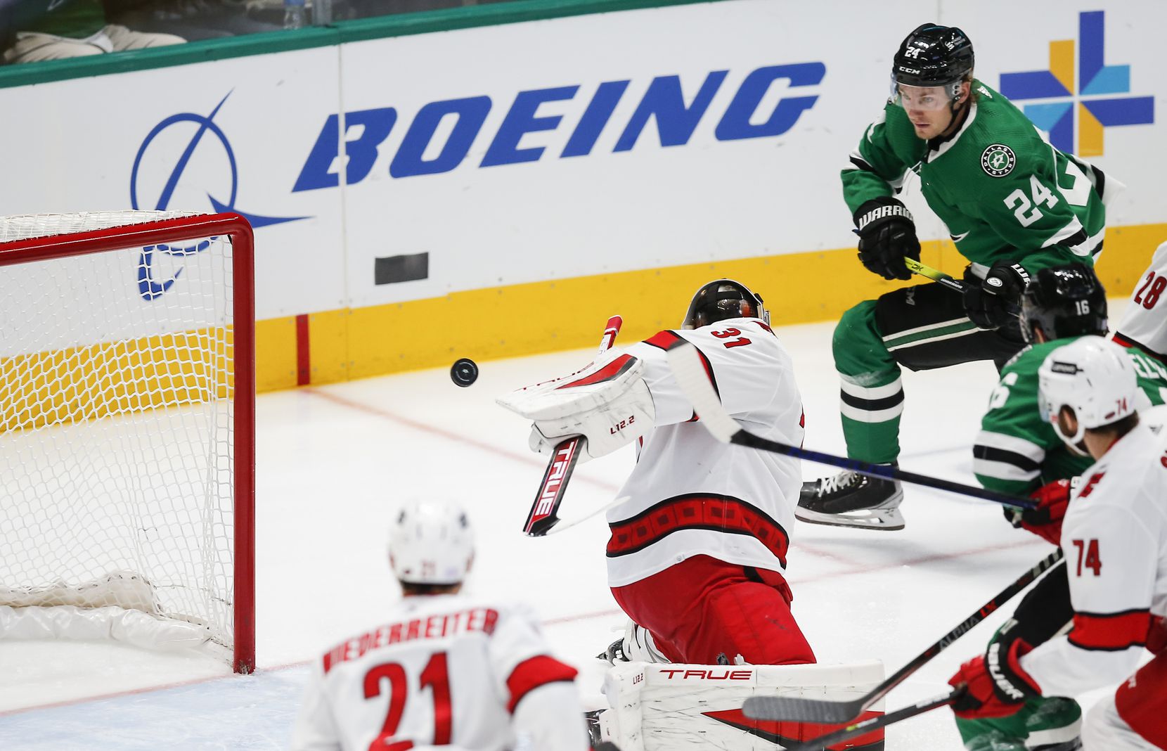 Dallas Stars forward Roope Hintz (24) shoots the puck past Carolina Hurricanes goaltender Frederik Andersen (31) for a goal during the first period of an NHL hockey game in Dallas, Tuesday, November 30, 2021. (Brandon Wade/Special Contributor)