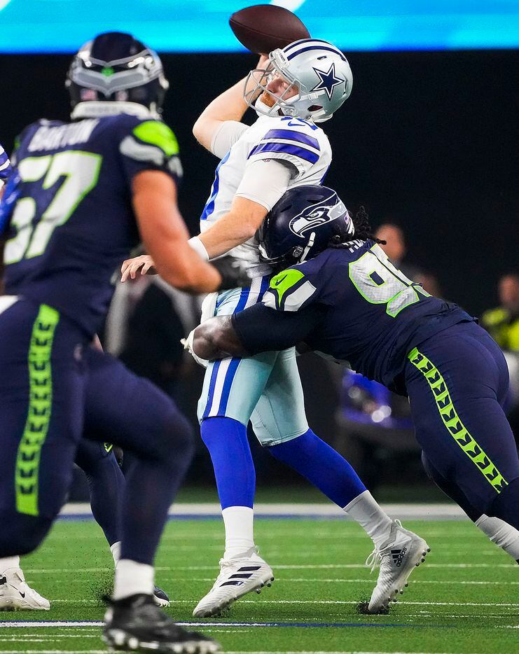Dallas Cowboys quarterback Cooper Rush (10) gets off a pass as he is hit by the Seattle...