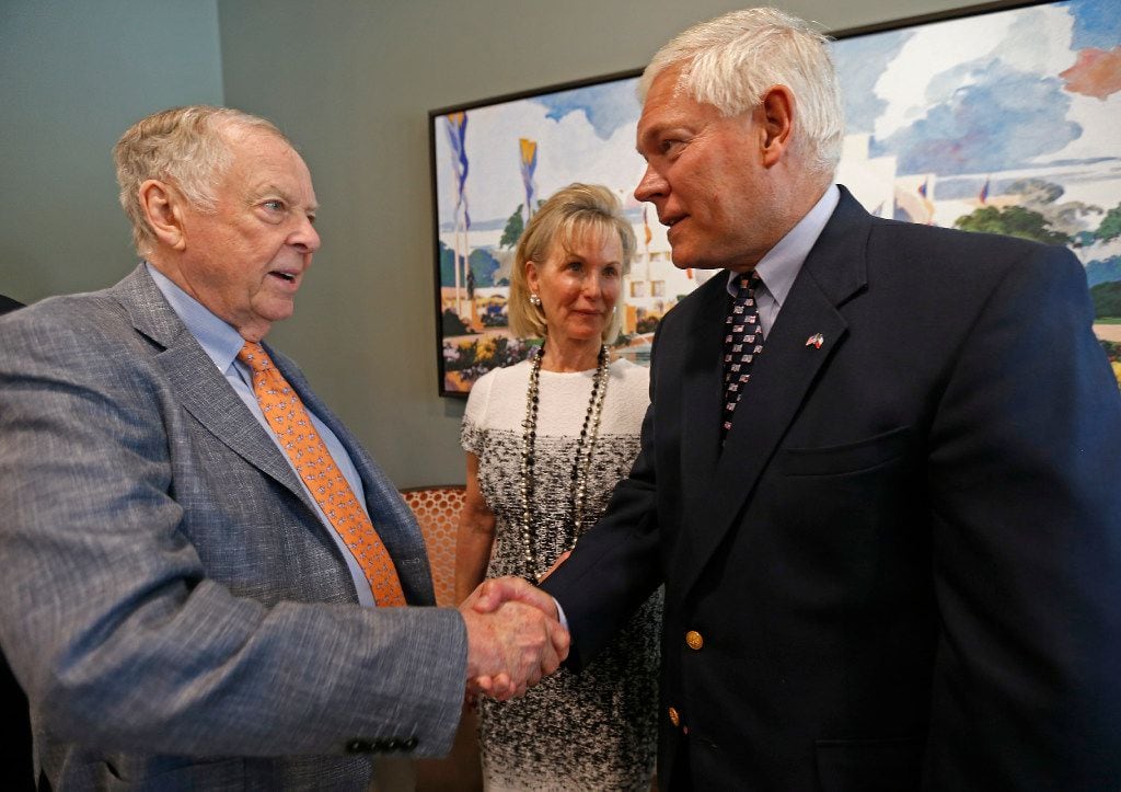 T. Boone Pickens (left) shakes hands with Rep. Pete Sessions (right) as Toni Brinker Pickens...